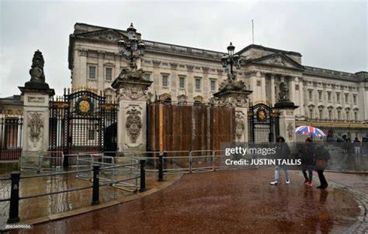 TOPSHOT - Britain's Prince Harry, Duke of Sussex and his wife Meghan, Duchess of Sussex emerge from the West Door of St George's Chapel, Windsor Ca...